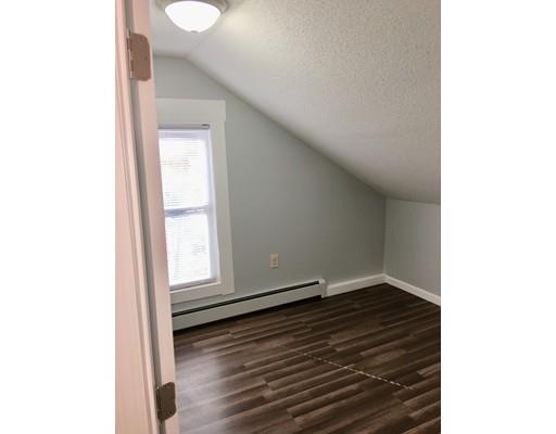 155 Methuen Street Springfield, MA 01119 - Photo 12 of 24 a view of an empty room with wooden floor and a window