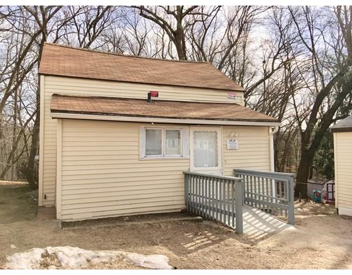 155 Methuen Street Springfield, MA 01119 - Photo 19 of 24 a view of a house with a small yard and wooden fence and large trees