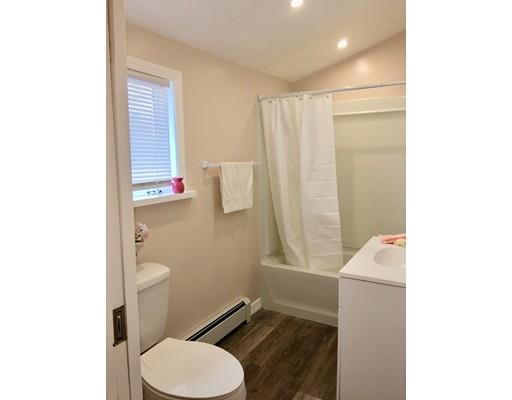 155 Methuen Street Springfield, MA 01119 - Photo 5 of 24 a white toilet sitting next to a bathroom sink and vanity