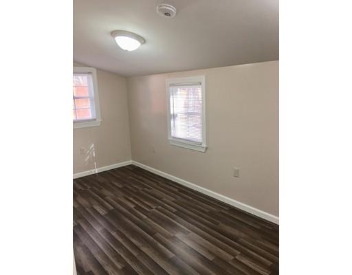 155 Methuen Street Springfield, MA 01119 - Photo 8 of 24 a view of an empty room with wooden floor and a window