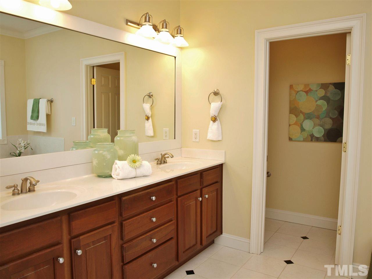2100 Summer Azure Way Raleigh, NC 27613 - Photo 11 of 25 a bathroom with a double vanity sink and a mirror
