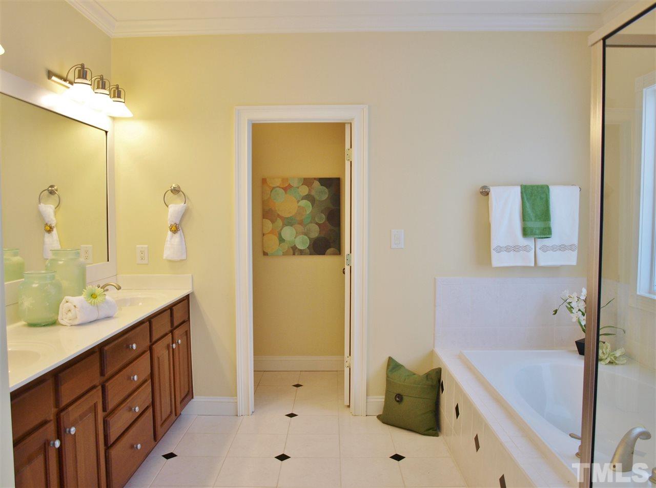 2100 Summer Azure Way Raleigh, NC 27613 - Photo 12 of 25 a bathroom with a tub sink and mirror