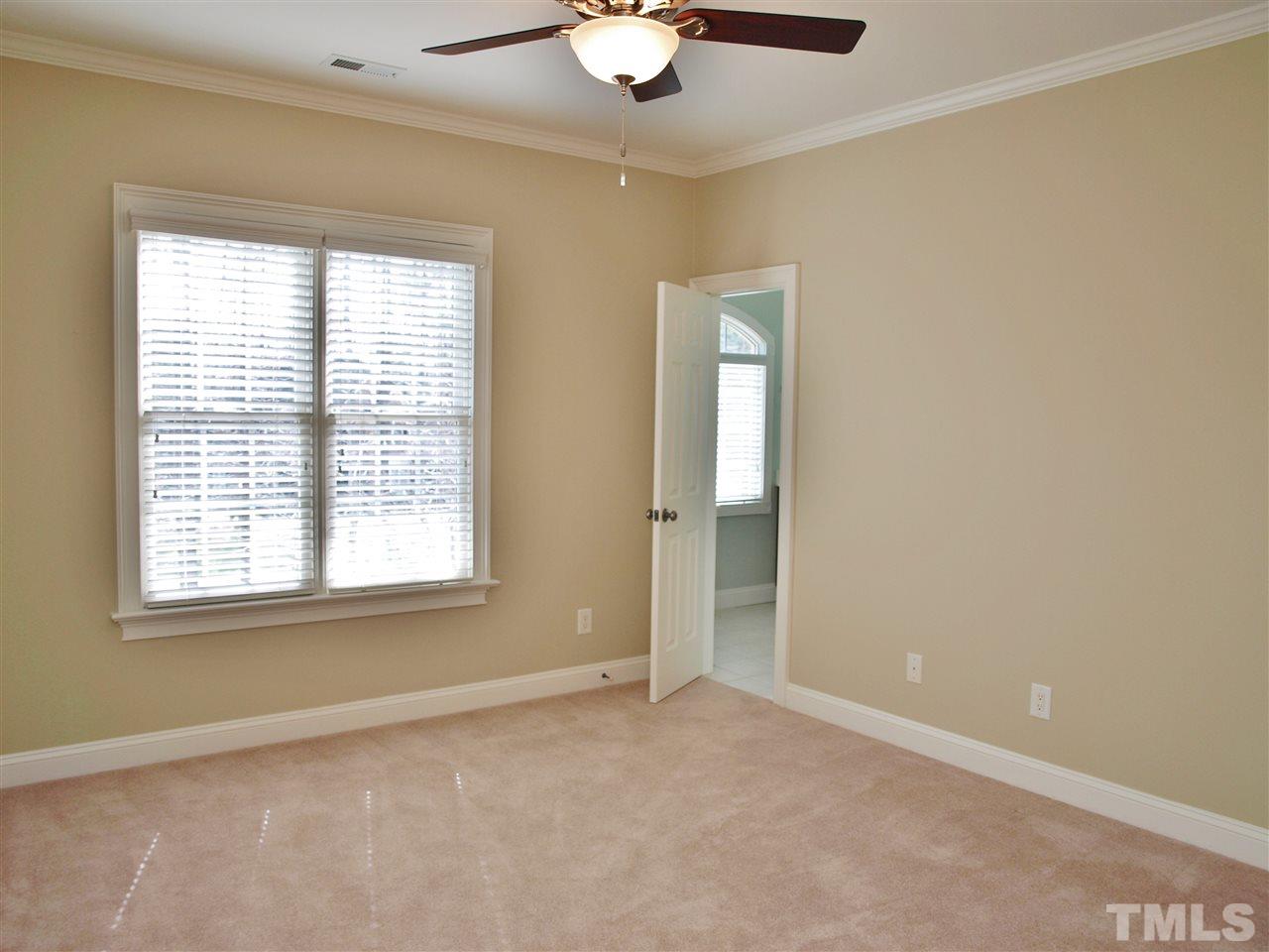 2100 Summer Azure Way Raleigh, NC 27613 - Photo 13 of 25 an empty room with windows and chandelier fan