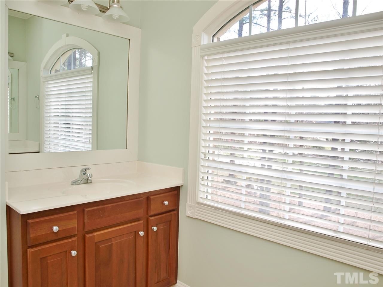 2100 Summer Azure Way Raleigh, NC 27613 - Photo 14 of 25 a bathroom with a sink a vanity and a window