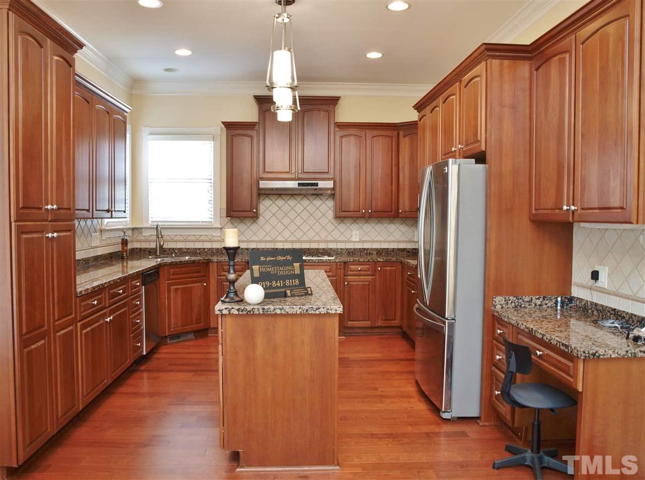 2100 Summer Azure Way Raleigh, NC 27613 - Photo 5 of 25 a kitchen with stainless steel appliances granite countertop a refrigerator a sink dishwasher a stove and white countertops with wooden floor