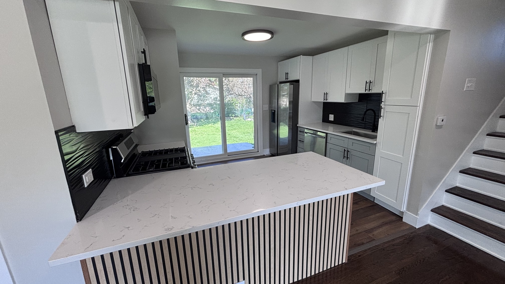 18314 Locust Street Lansing, IL 60438 - Photo 5 of 14 a kitchen with stainless steel appliances a refrigerator sink and stove