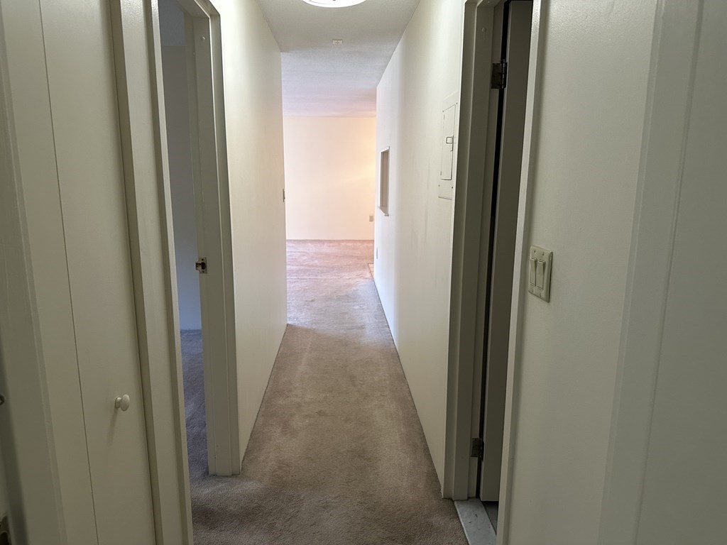 2 Summit Drive, Unit 21 Wakefield, MA 01880 - Photo 16 of 19 a view of a hallway with a wooden door
