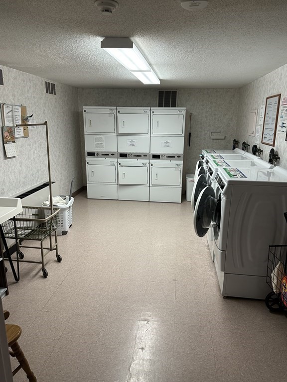 2 Summit Drive, Unit 21 Wakefield, MA 01880 - Photo 17 of 19 a storage room with washer and dryer