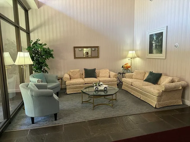 a living room with furniture and a potted plant