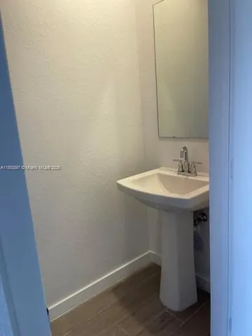 a bathroom with a sink and mirror