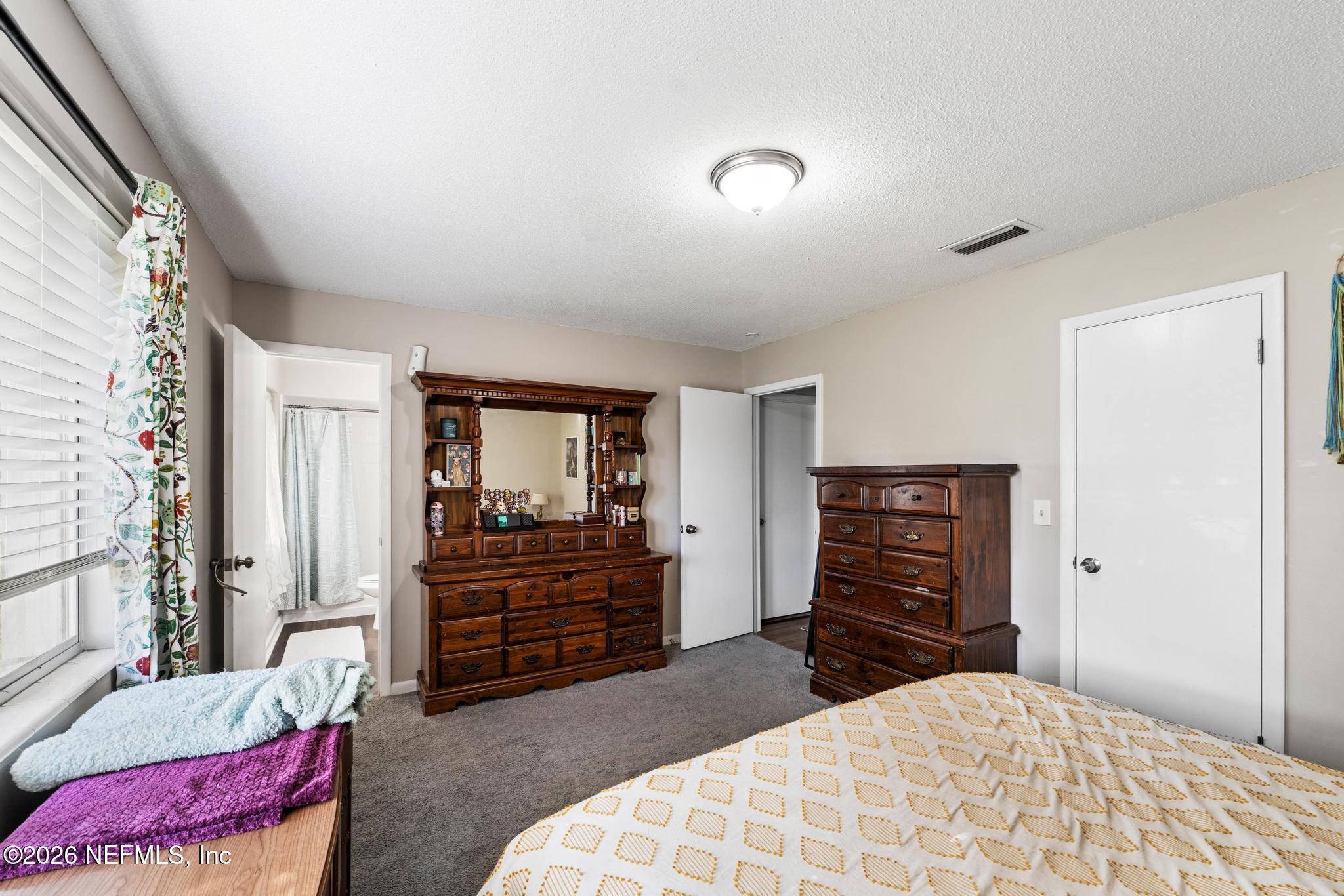 5628 Fort Sumter Road Jacksonville, FL 32210 - Photo 11 of 45 a bedroom with a bed and furniture