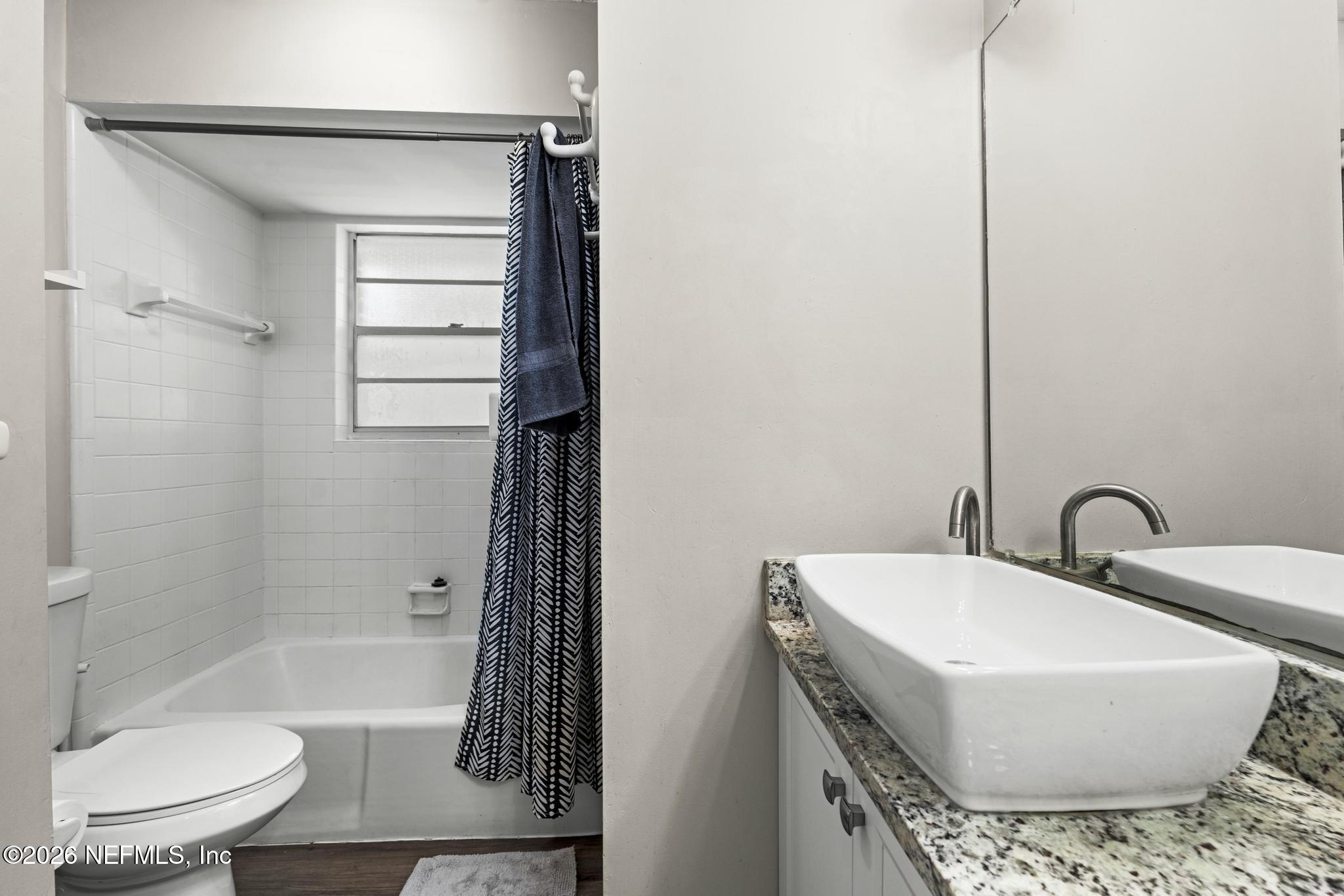 5628 Fort Sumter Road Jacksonville, FL 32210 - Photo 13 of 45 a bathroom with a sink toilet and shower