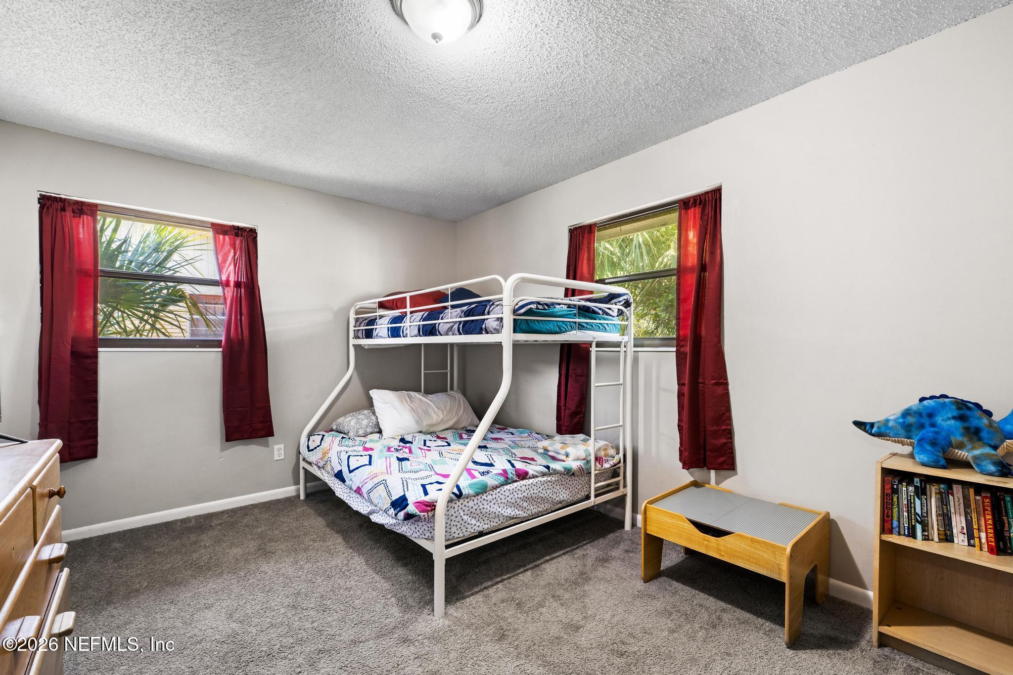 5628 Fort Sumter Road Jacksonville, FL 32210 - Photo 14 of 45 a bedroom with a bed and a window