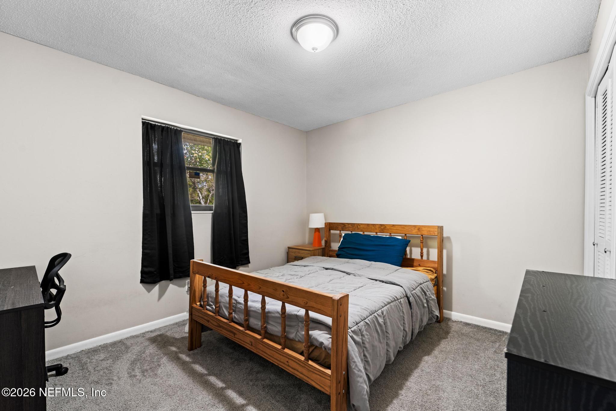 5628 Fort Sumter Road Jacksonville, FL 32210 - Photo 15 of 45 a bedroom with a bed and a window