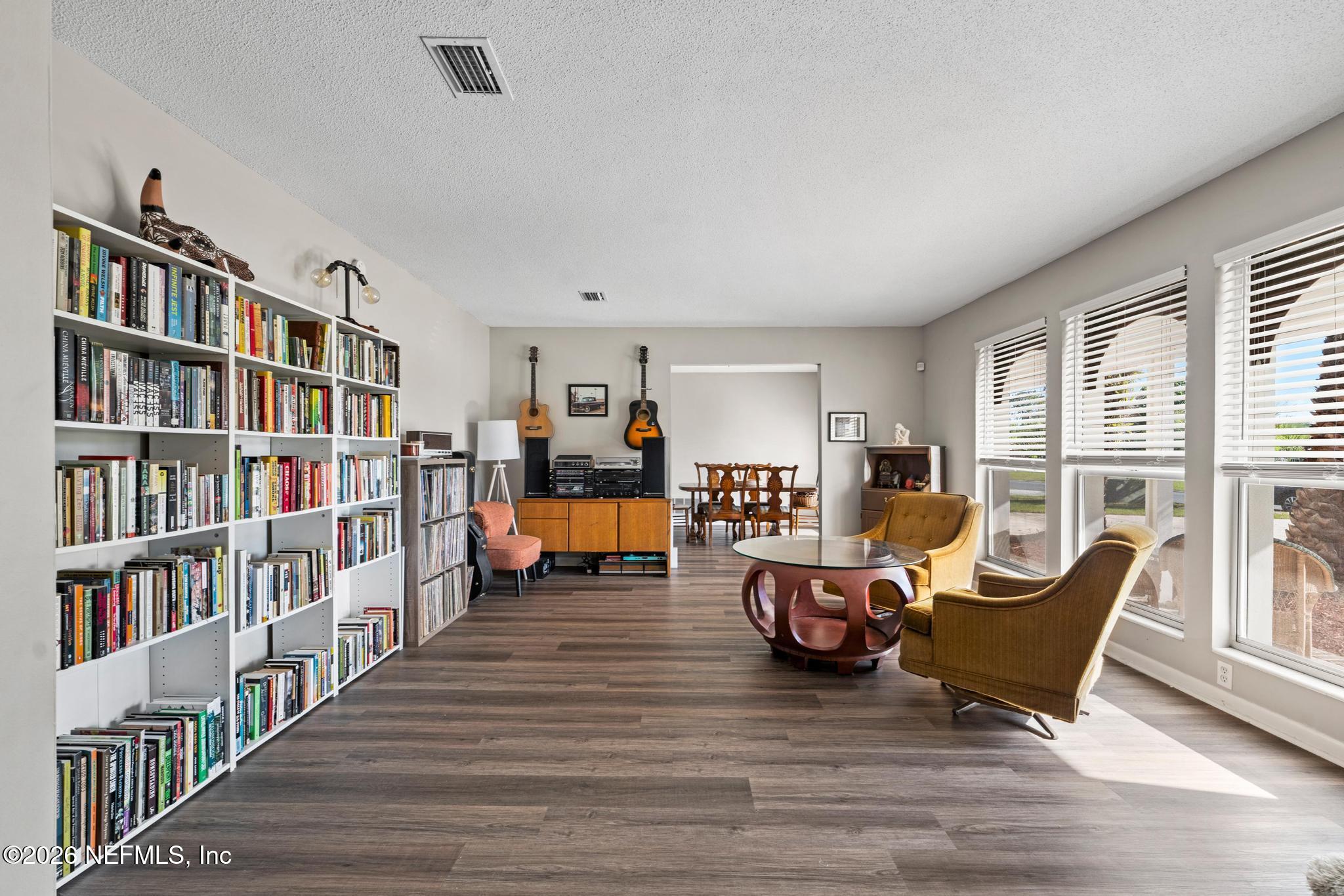 5628 Fort Sumter Road Jacksonville, FL 32210 - Photo 19 of 45 a living room with furniture and a book shelf