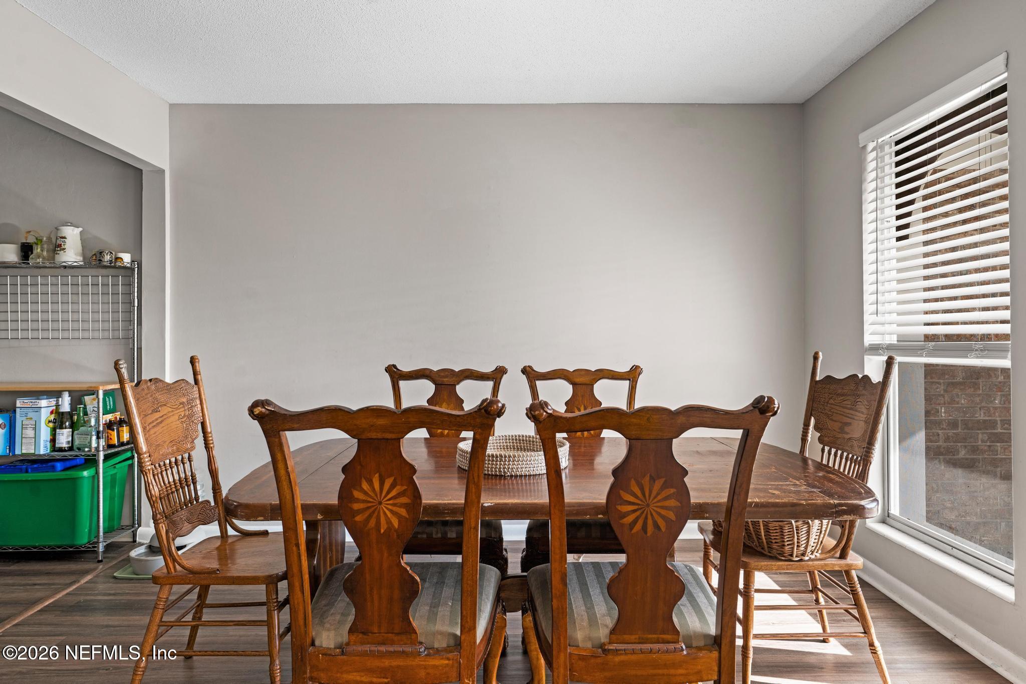 5628 Fort Sumter Road Jacksonville, FL 32210 - Photo 22 of 45 a view of a dining room with furniture and wooden floor