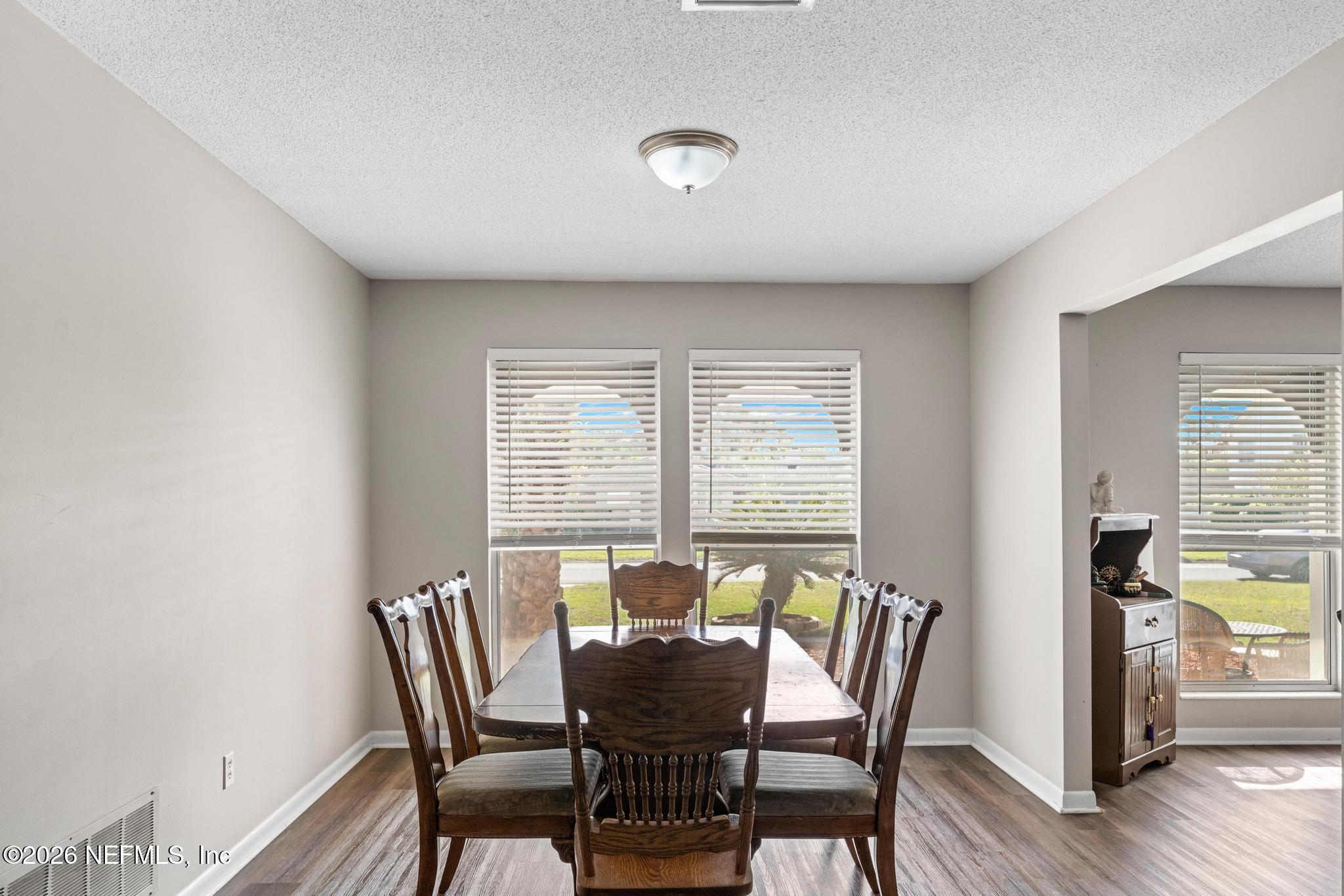 5628 Fort Sumter Road Jacksonville, FL 32210 - Photo 28 of 45 a view of a dining room with furniture and wooden floor