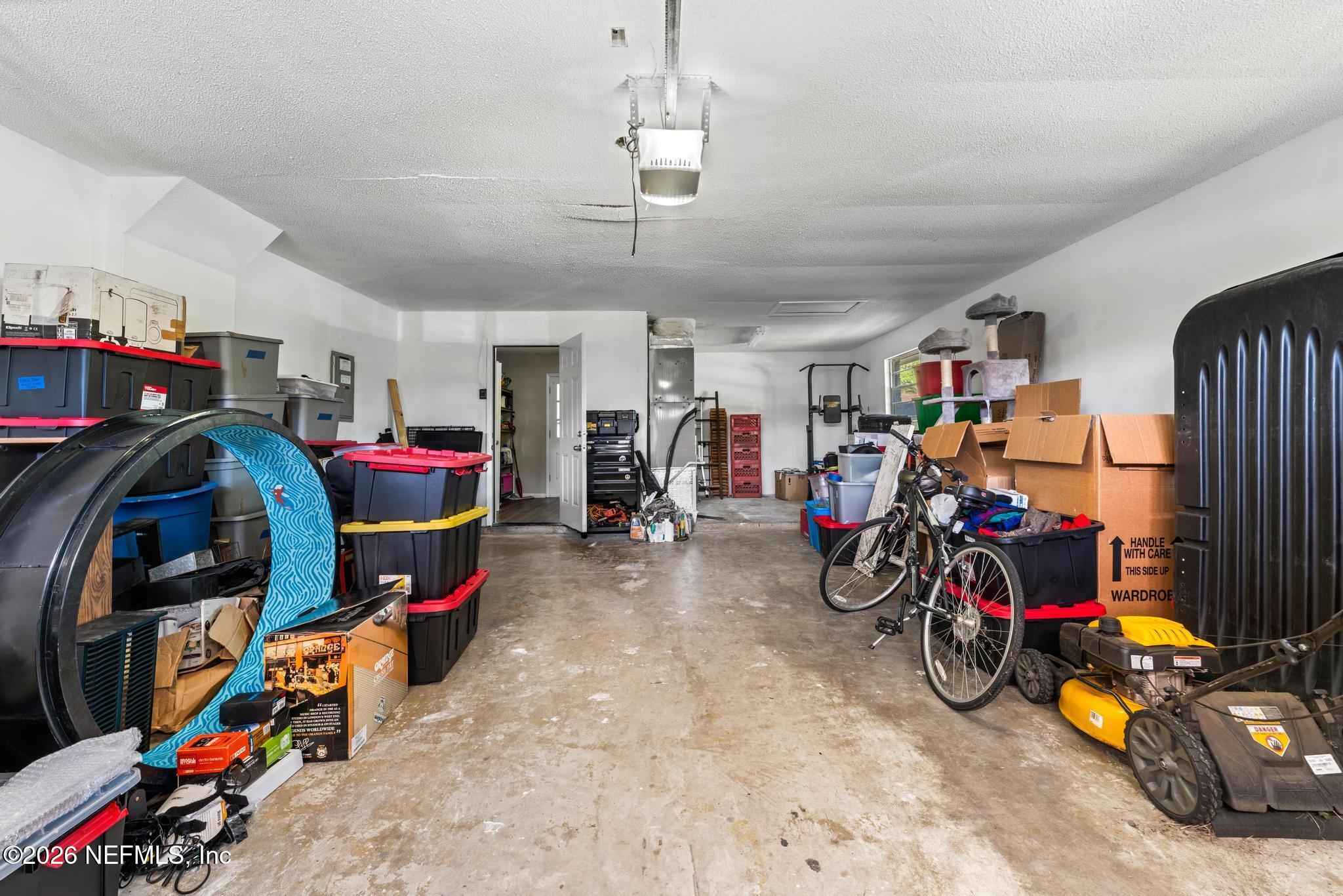 5628 Fort Sumter Road Jacksonville, FL 32210 - Photo 31 of 45 a view of a garage with a bike and car