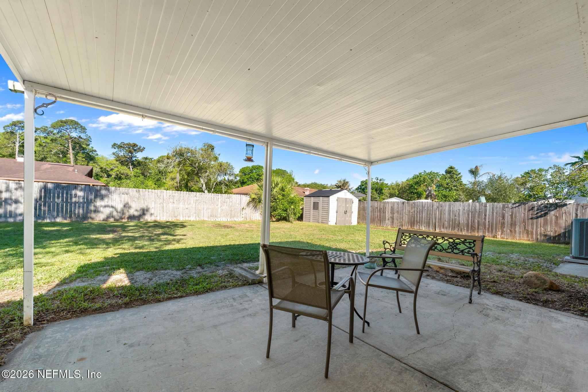 5628 Fort Sumter Road Jacksonville, FL 32210 - Photo 39 of 45 a view of a chairs and table in patio with a yard