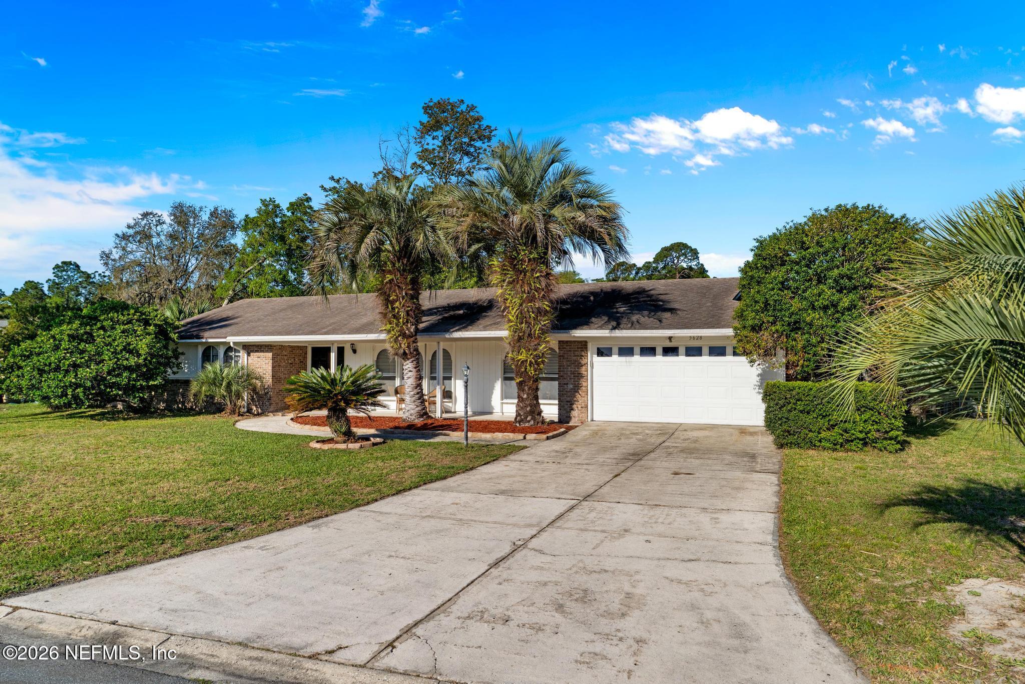5628 Fort Sumter Road Jacksonville, FL 32210 - Photo 5 of 45 a view of a house with swimming pool and a yard