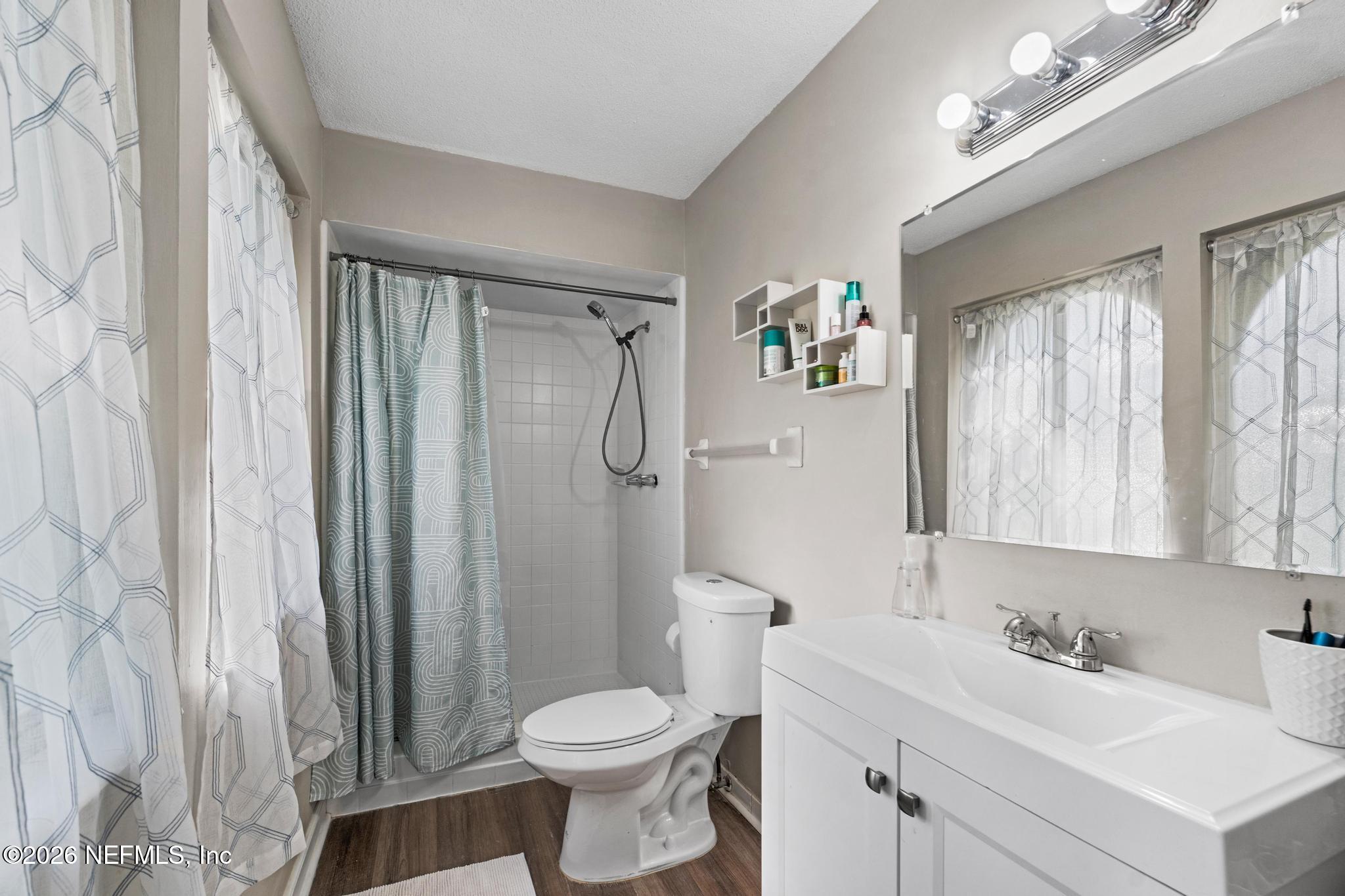 5628 Fort Sumter Road Jacksonville, FL 32210 - Photo 8 of 45 a bathroom with a sink toilet a mirror and shower