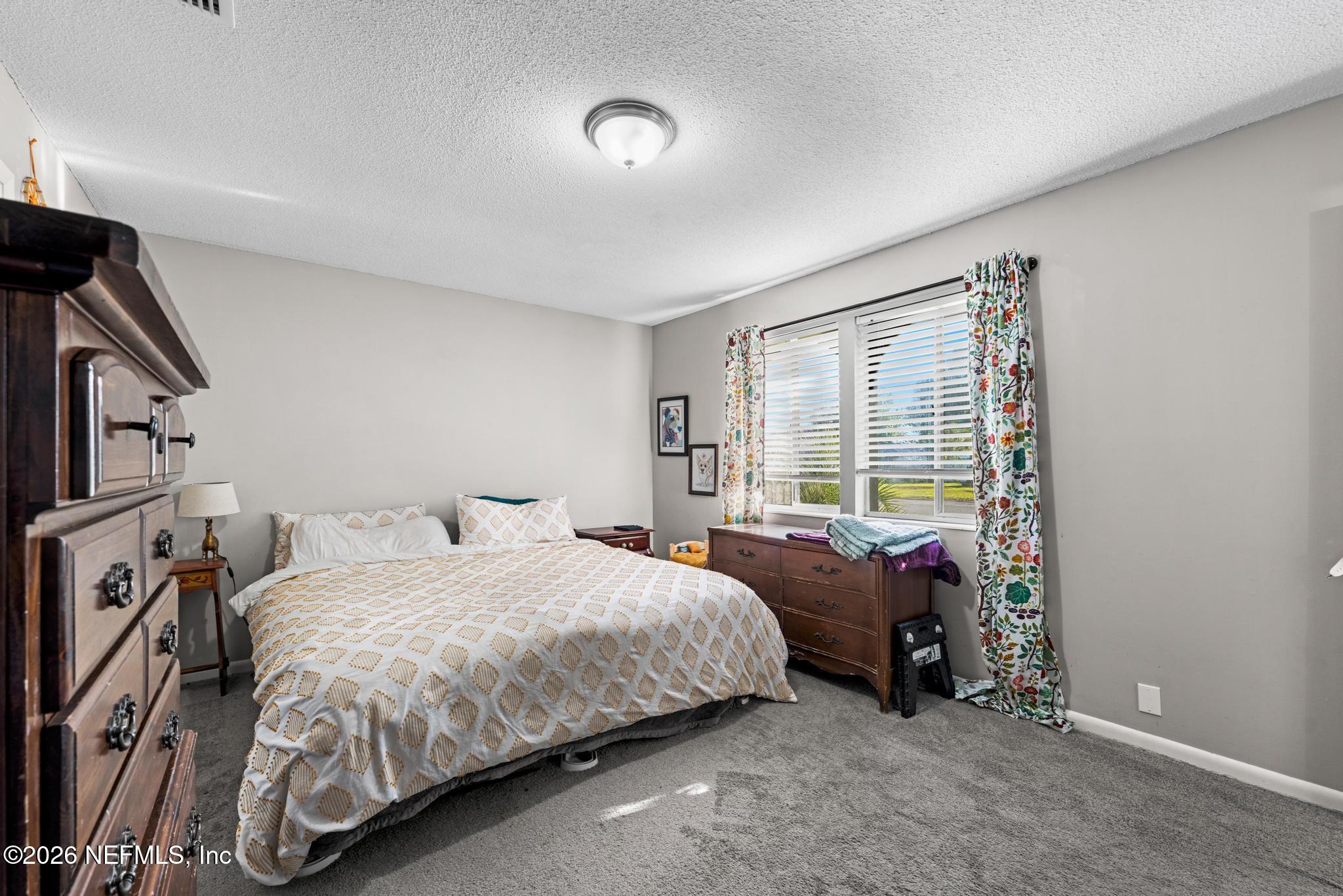 5628 Fort Sumter Road Jacksonville, FL 32210 - Photo 9 of 45 a bedroom with a bed and a tv