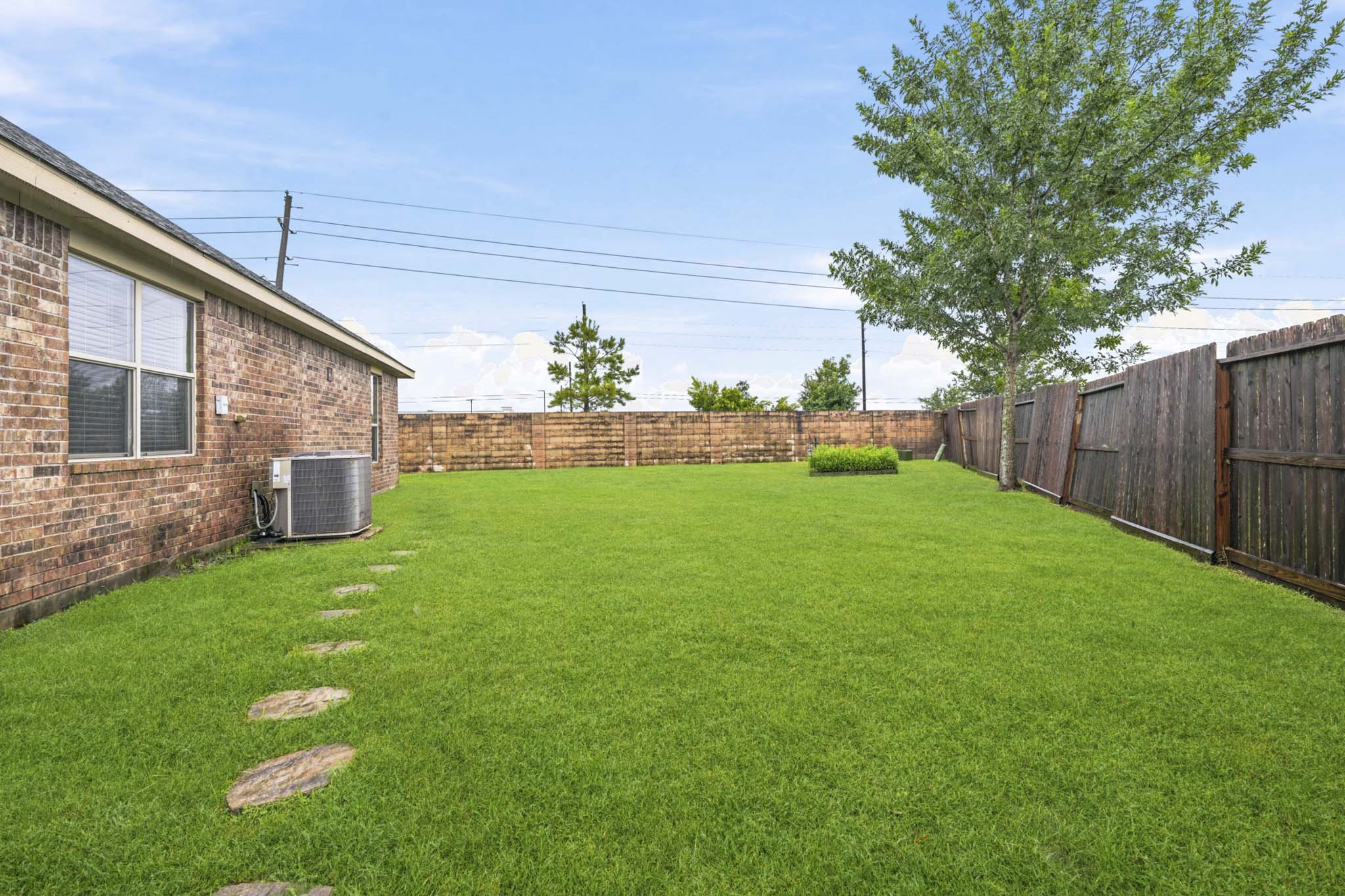 2502 Tiger Eye Drive Rosharon, TX 77583 - Photo 28 of 40 Spacious back yard with plenty of space to enjoy some fresh air! Irrigated garden bed in the back corner is the perfect spot to grow fresh veggies or herbs.