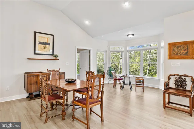 a dining room with furniture and wooden floor
