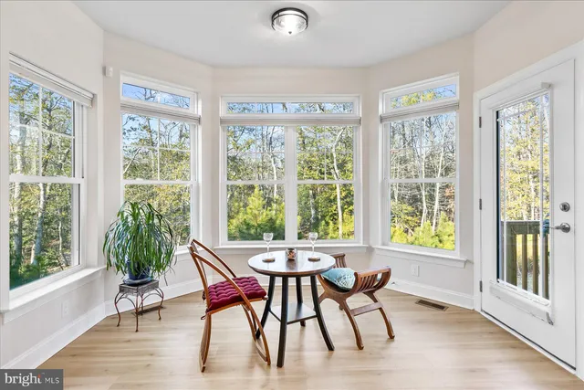 a view of a dining room with furniture and windows