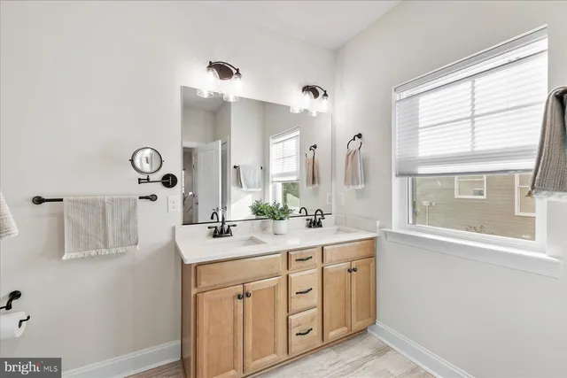 a spacious bathroom with a granite countertop sink and a mirror