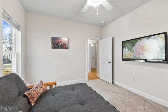 a bedroom with furniture and a flat screen tv