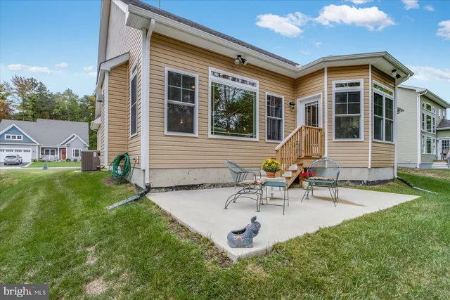 a view of a house with backyard sitting area and garden