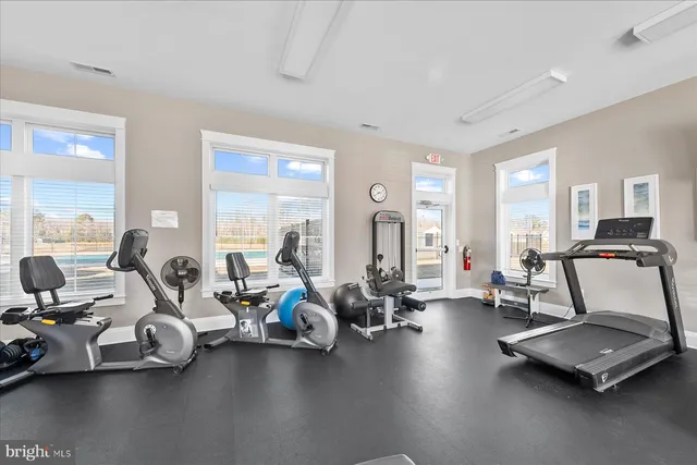 a room with gym equipment and a large window