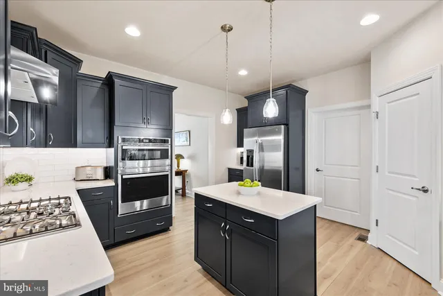 a kitchen with a stove a refrigerator and a sink