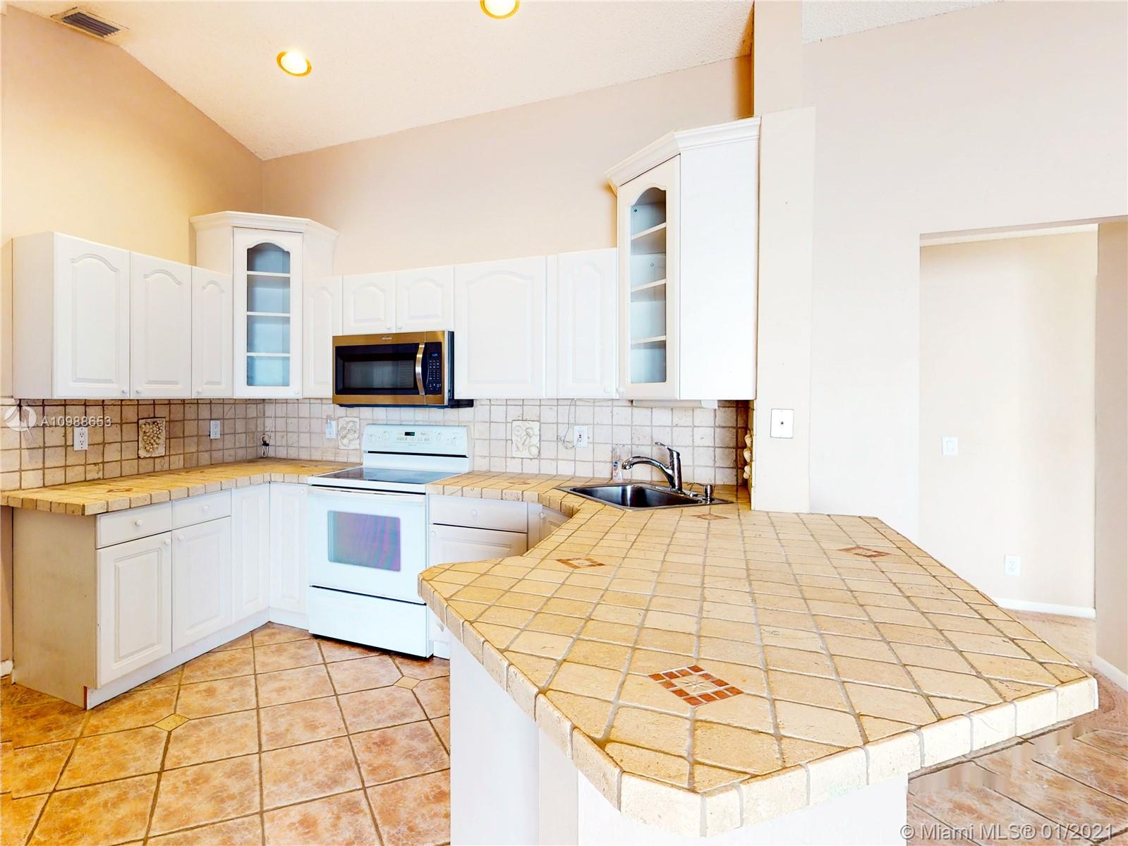 573 Talavera Road Weston, FL 33326 - Photo 7 of 18 Open kitchen with dining counter