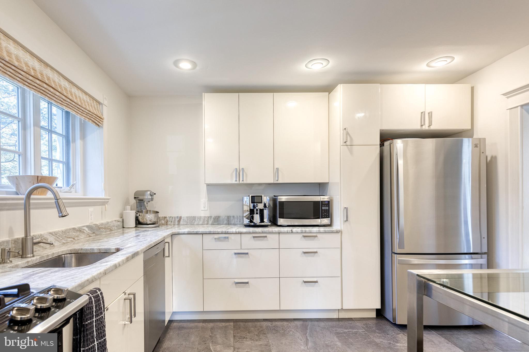 4010 Roundtop Road Baltimore, MD 21218 - Photo 16 of 51 a kitchen with white cabinets and stainless steel appliances