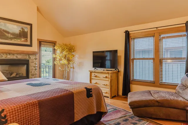 a bedroom with a bed and flat screen tv