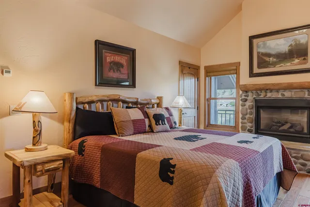 a bed room with a bed and a fireplace