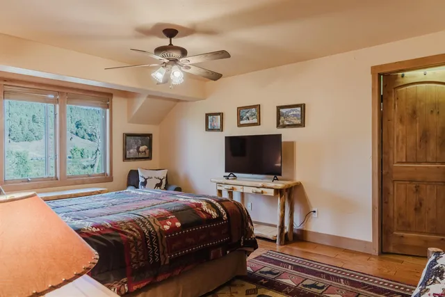 a bedroom with a bed and a flat screen tv