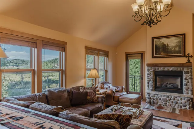 a living room with furniture a fireplace and a window