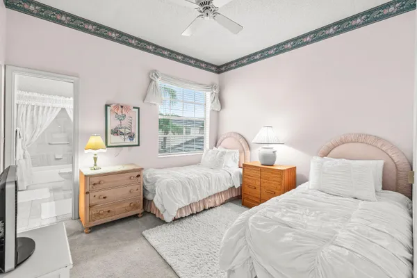 a bedroom with a bed and a chandelier fan