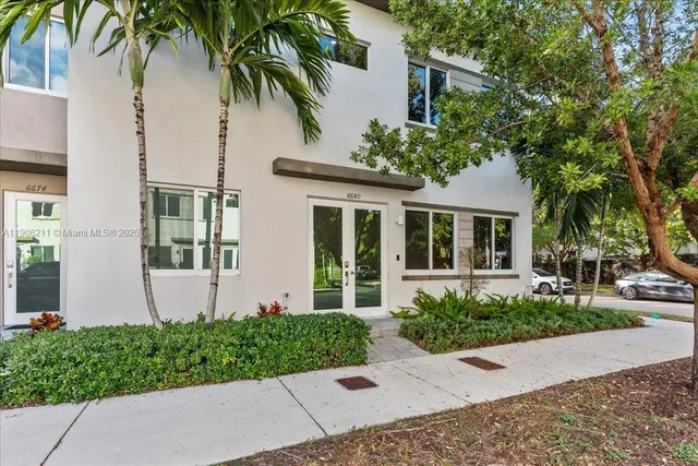 a front view of a house with a garden