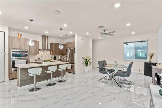 a living room with furniture and kitchen view