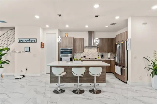 a large kitchen with a table and chairs