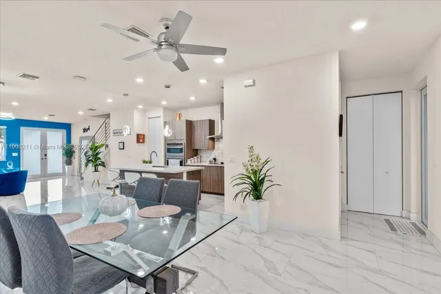 an open kitchen with dining table and sink