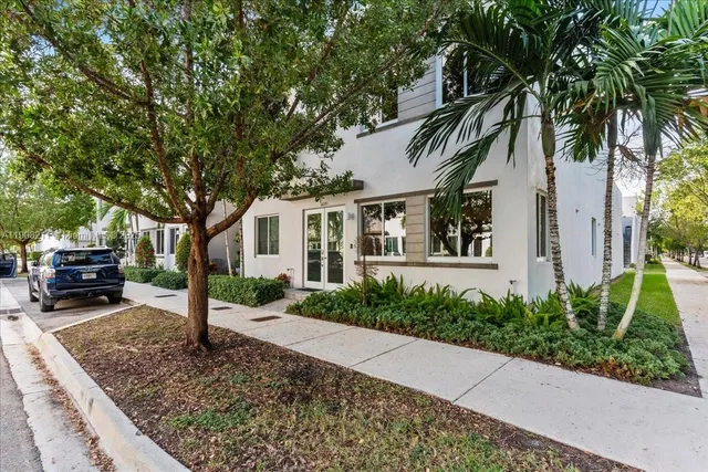 a front view of a house with a garden