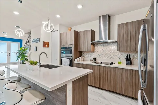 a kitchen with granite countertop a sink stainless steel appliances and cabinets