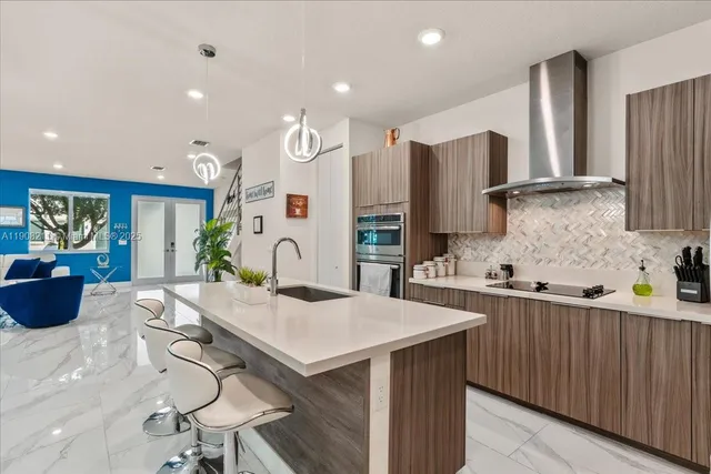 a kitchen with stainless steel appliances a sink stove and refrigerator