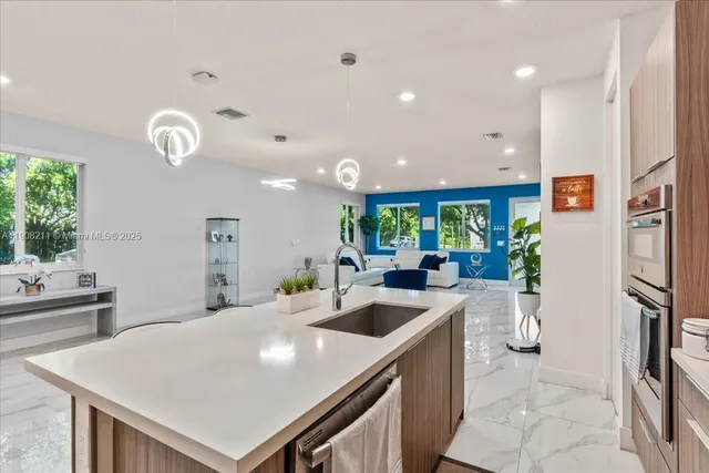 a large white kitchen with a large window