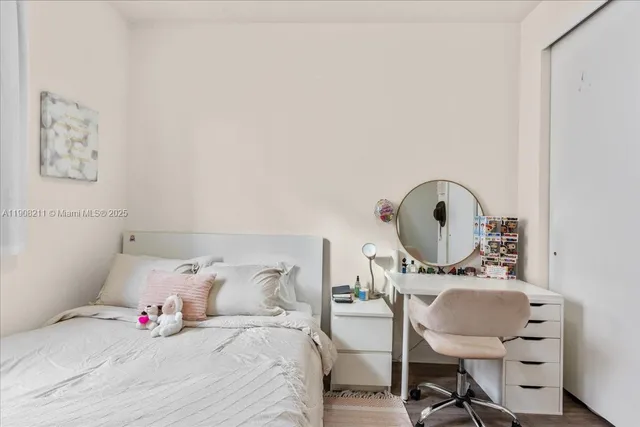 a bedroom with a bed a table and chair